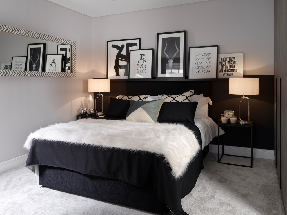 Mid-sized scandinavian bedroom in London with grey walls, carpet and grey floor.