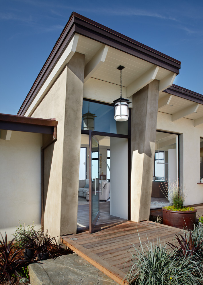 Inspiration for an expansive contemporary front door in Los Angeles with a pivot front door and a glass front door.