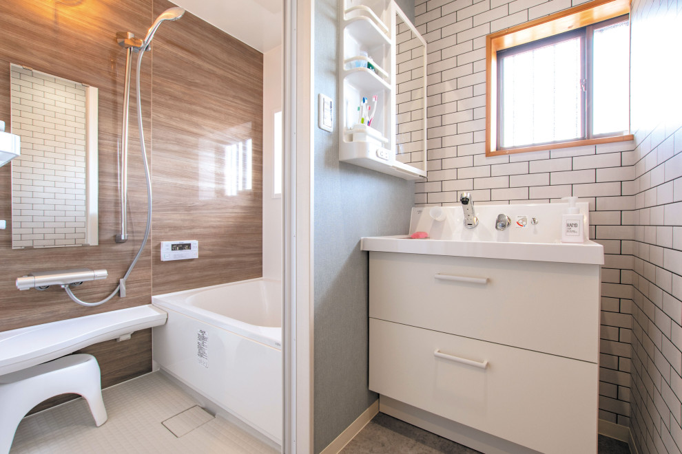 Design ideas for a small eclectic bathroom in Other with flat-panel cabinets, white cabinets, multi-coloured walls, vinyl floors, an integrated sink, grey floor, white benchtops, wallpaper and wallpaper.