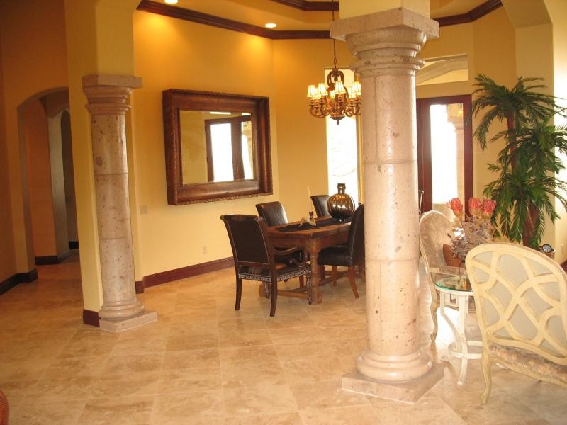 Inspiration for a large porcelain tile great room remodel with yellow walls and no fireplace