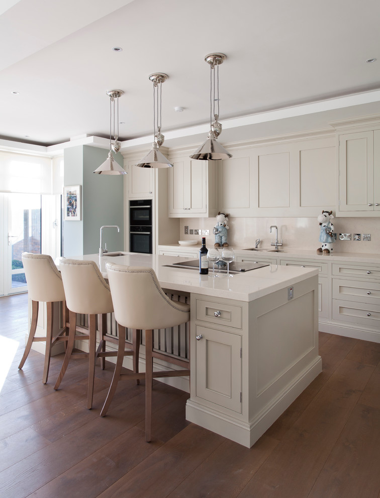 This is an example of a transitional kitchen in Dublin with an undermount sink, shaker cabinets, beige cabinets, beige splashback, black appliances, medium hardwood floors and with island.