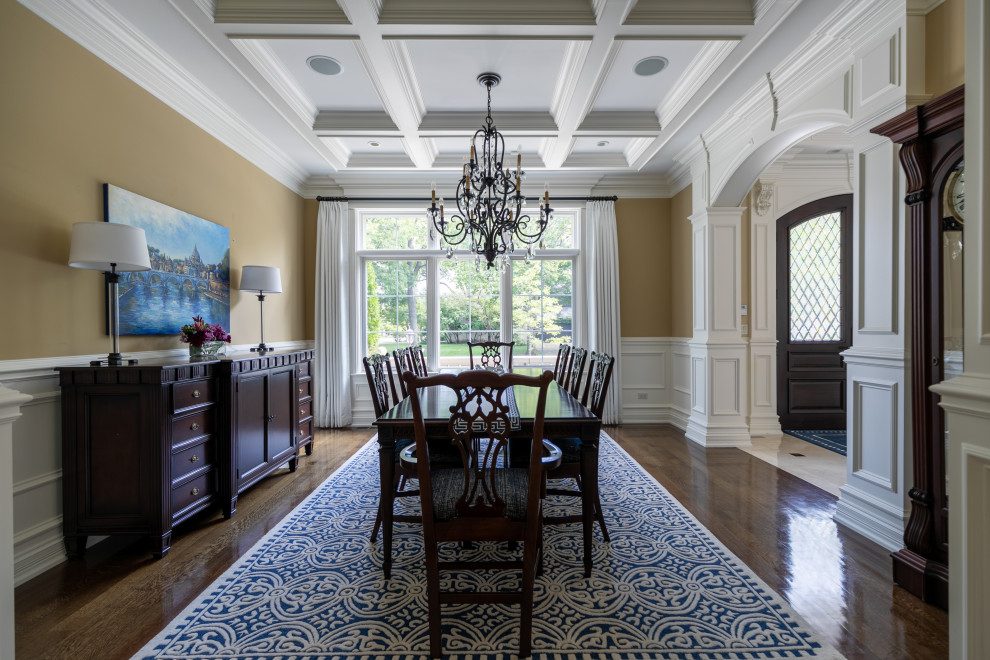 Design ideas for a medium sized classic enclosed dining room in Chicago with beige walls, dark hardwood flooring, no fireplace and a coffered ceiling.