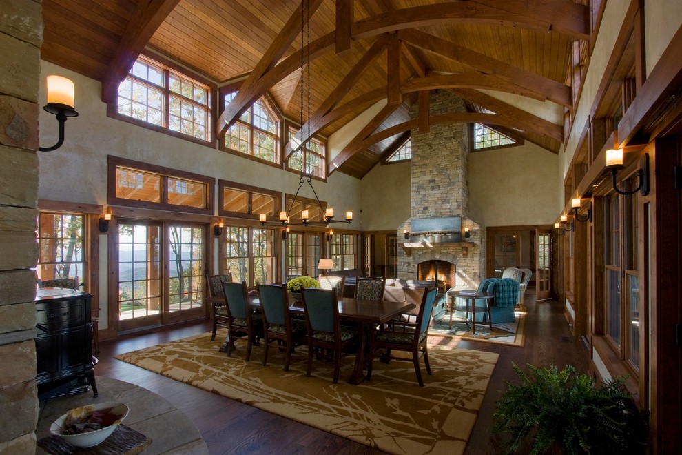 Inspiration for a large country open plan dining in Boston with beige walls, dark hardwood floors, a standard fireplace and a brick fireplace surround.
