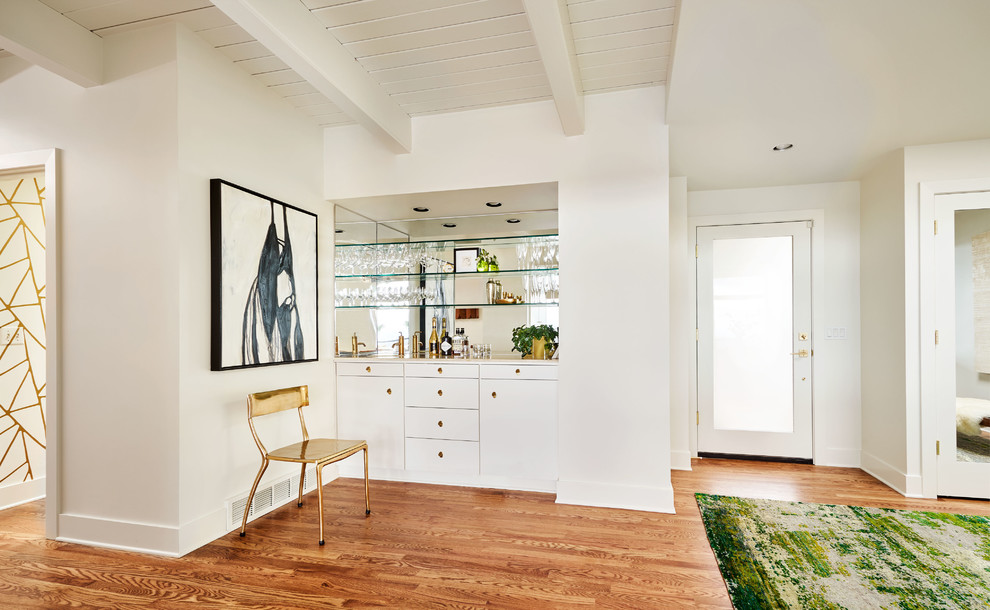 This is an example of a mid-sized contemporary entryway in Portland with white walls, medium hardwood floors, a single front door, a glass front door and brown floor.