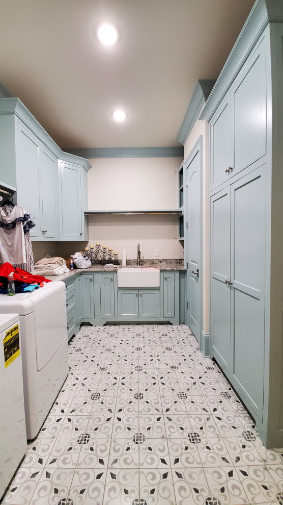 Photo of a transitional laundry room in Other with shaker cabinets and granite benchtops.