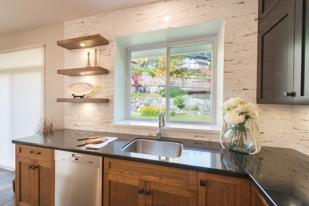 Example of a large transitional slate floor and multicolored floor kitchen pantry design in Vancouver with an undermount sink, shaker cabinets, dark wood cabinets, quartz countertops, white backsplash, porcelain backsplash, stainless steel appliances, an island and white countertops