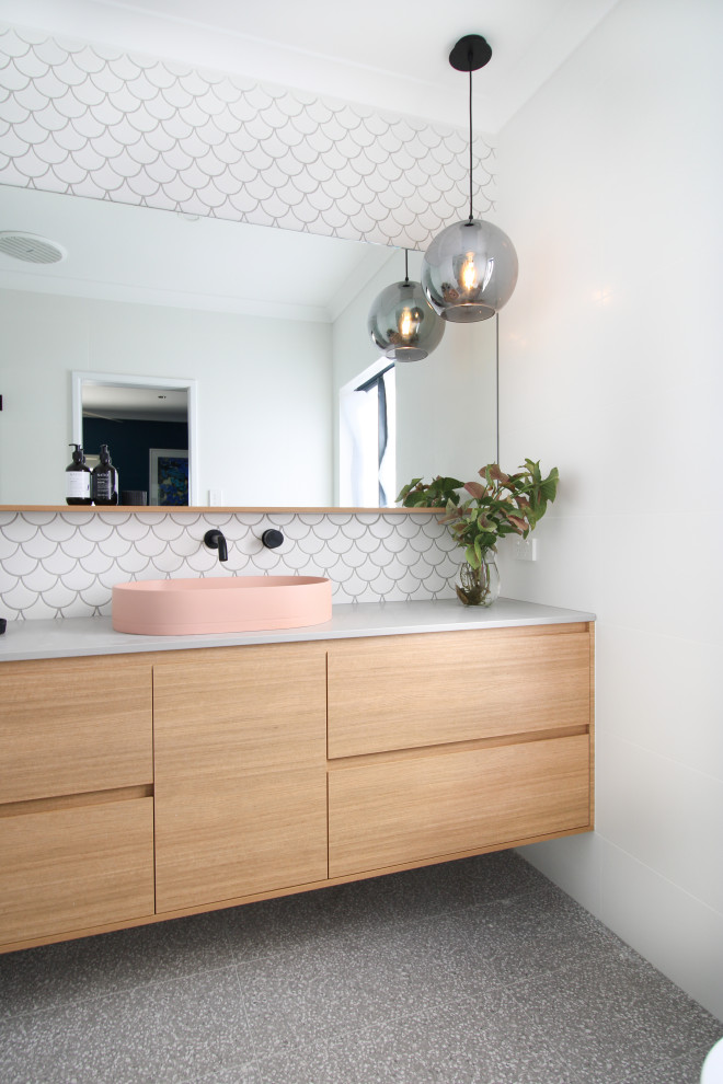 Photo of a mid-sized modern master bathroom in Perth with furniture-like cabinets, medium wood cabinets, an alcove shower, a one-piece toilet, white tile, mosaic tile, white walls, porcelain floors, a vessel sink, engineered quartz benchtops, grey floor, a hinged shower door, grey benchtops, a shower seat, a single vanity and a floating vanity.