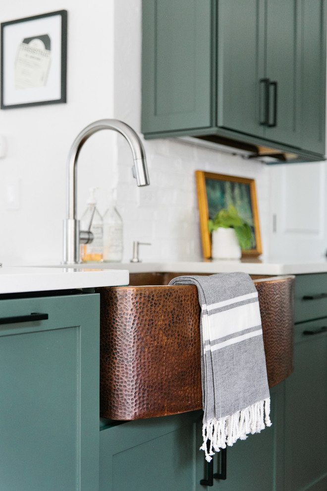 Example of a mid-sized transitional galley medium tone wood floor and brown floor eat-in kitchen design in Denver with a farmhouse sink, shaker cabinets, green cabinets, quartz countertops, white backsplash, brick backsplash, stainless steel appliances, a peninsula and white countertops