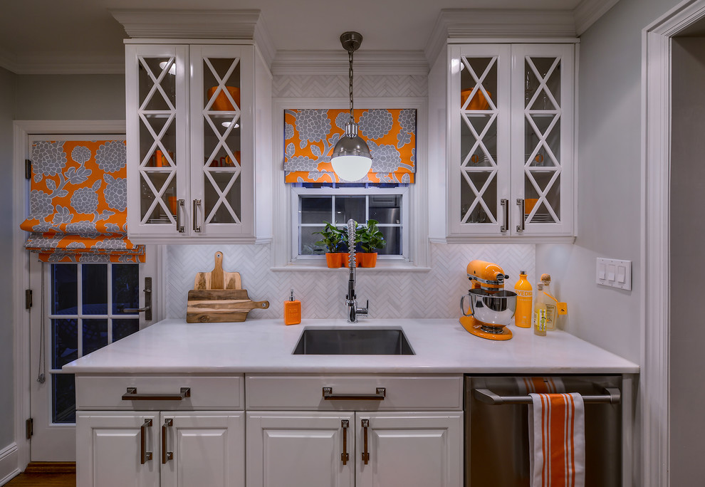 Kitchen - small transitional medium tone wood floor kitchen idea in New York with an undermount sink, raised-panel cabinets, white cabinets, white backsplash and stainless steel appliances