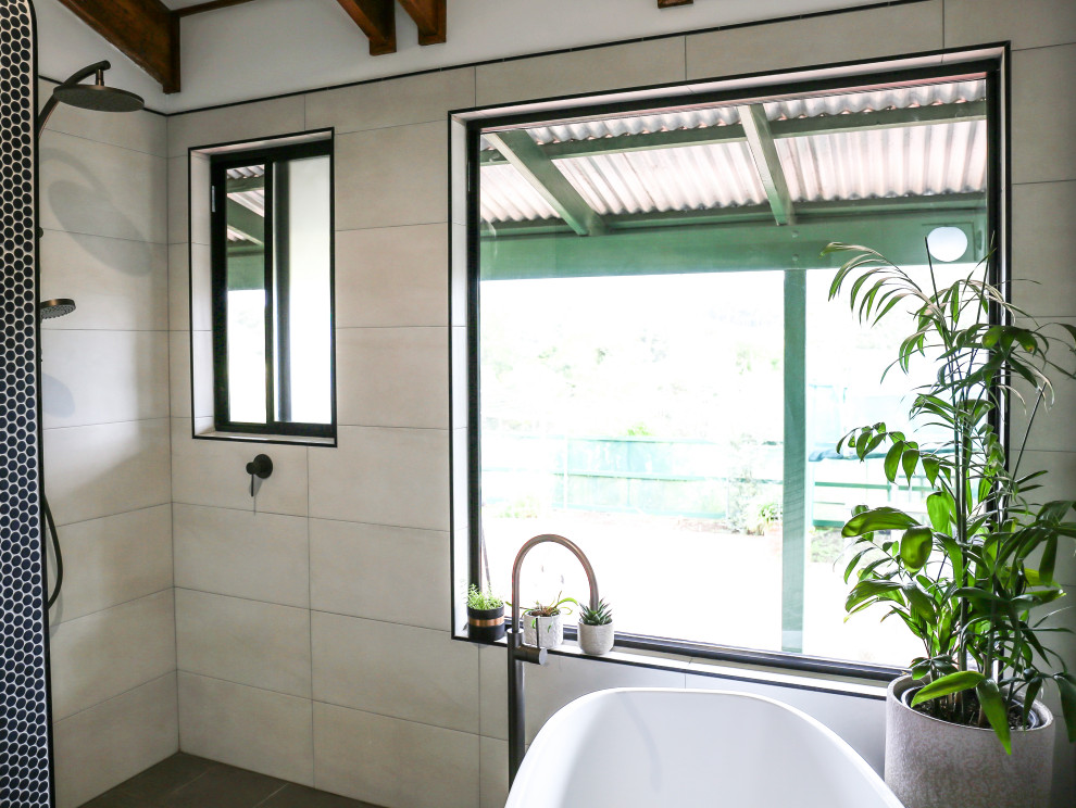 Photo of a large contemporary ensuite bathroom in Other with freestanding cabinets, dark wood cabinets, a freestanding bath, a walk-in shower, a one-piece toilet, beige tiles, ceramic tiles, white walls, ceramic flooring, a vessel sink, soapstone worktops, multi-coloured floors, an open shower, green worktops, a wall niche, a single sink, a floating vanity unit, a vaulted ceiling and tongue and groove walls.