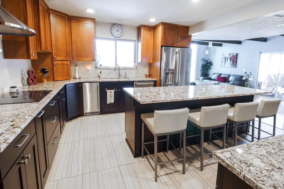 Inspiration for a large transitional u-shaped porcelain tile and gray floor eat-in kitchen remodel with shaker cabinets, dark wood cabinets, granite countertops, white backsplash, subway tile backsplash, stainless steel appliances and an island