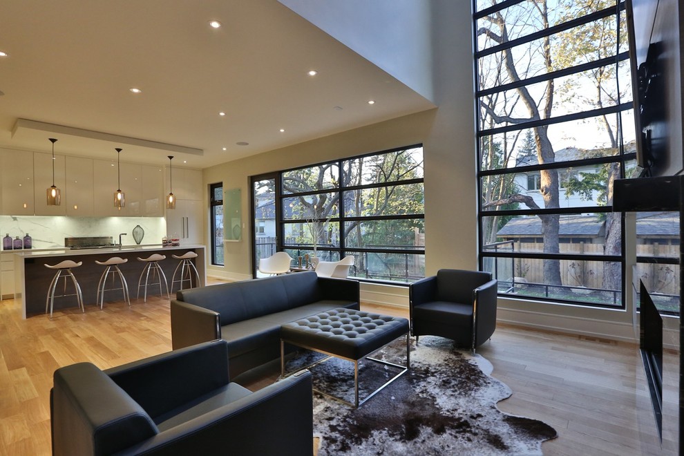 Expansive contemporary open concept living room in Toronto with grey walls, light hardwood floors, a ribbon fireplace, a tile fireplace surround and a wall-mounted tv.