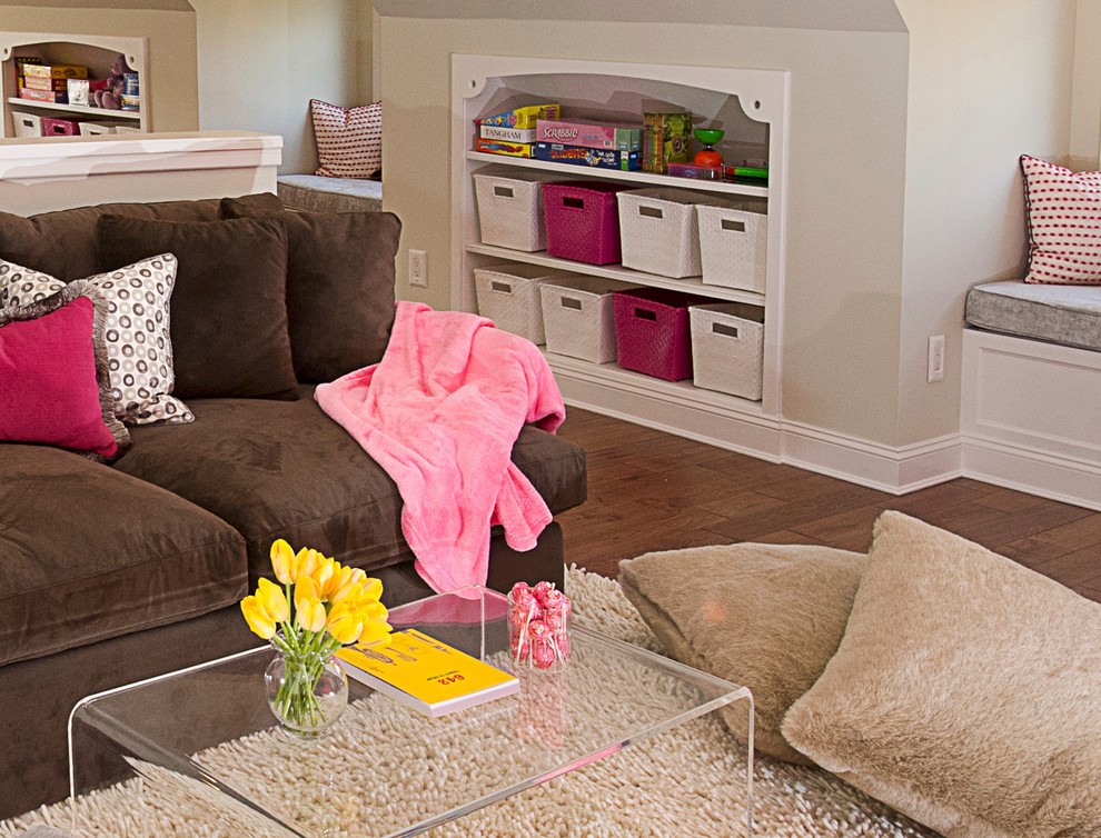 Design ideas for an expansive transitional kids' playroom for kids 4-10 years old and girls in New York with pink walls and medium hardwood floors.