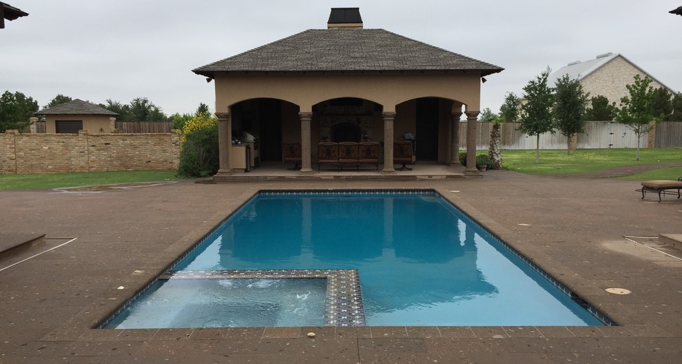 Large mediterranean backyard rectangular lap pool in Austin with natural stone pavers.