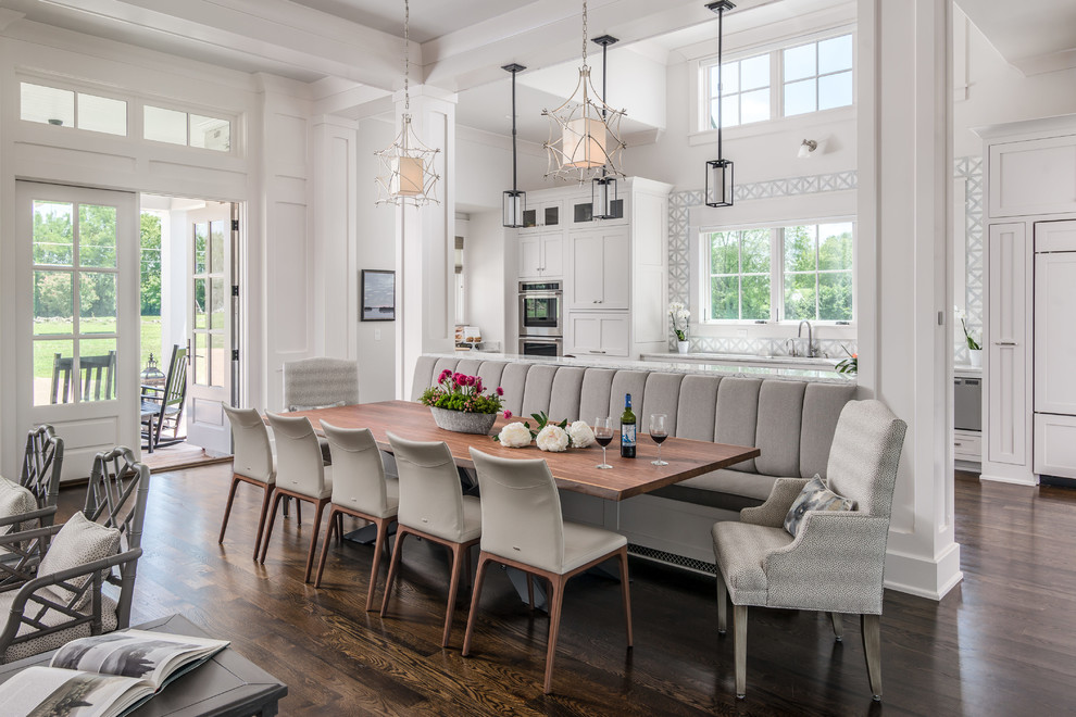 Design ideas for a country kitchen/dining combo in Nashville with white walls, dark hardwood floors and brown floor.