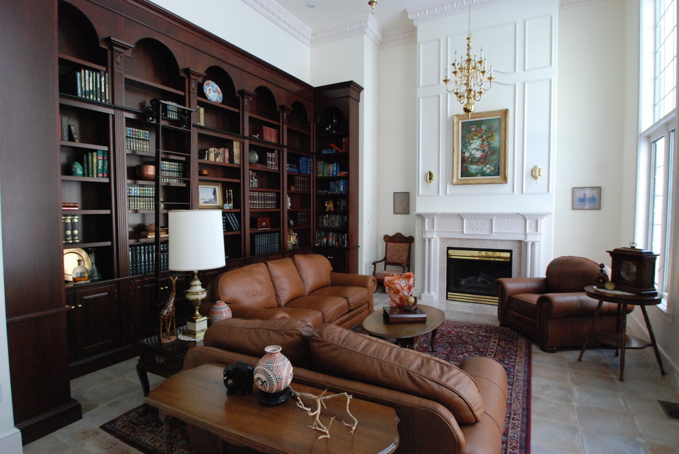 This is an example of a large traditional enclosed living room in Philadelphia with a library, white walls, ceramic floors, a standard fireplace, a plaster fireplace surround and no tv.