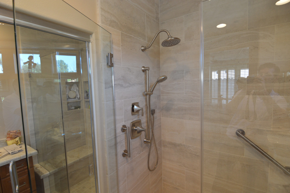 Photo of a medium sized classic family bathroom in Los Angeles with raised-panel cabinets, medium wood cabinets, an alcove shower, beige walls, porcelain flooring, a submerged sink, quartz worktops, beige floors, a hinged door, beige worktops, double sinks and a built in vanity unit.