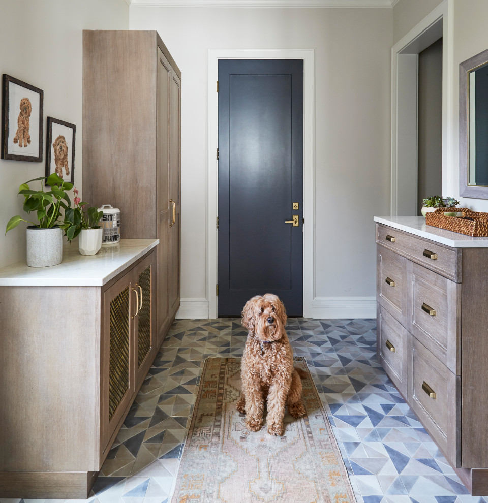 Eclectic mudroom in Chicago with white walls and grey floor.