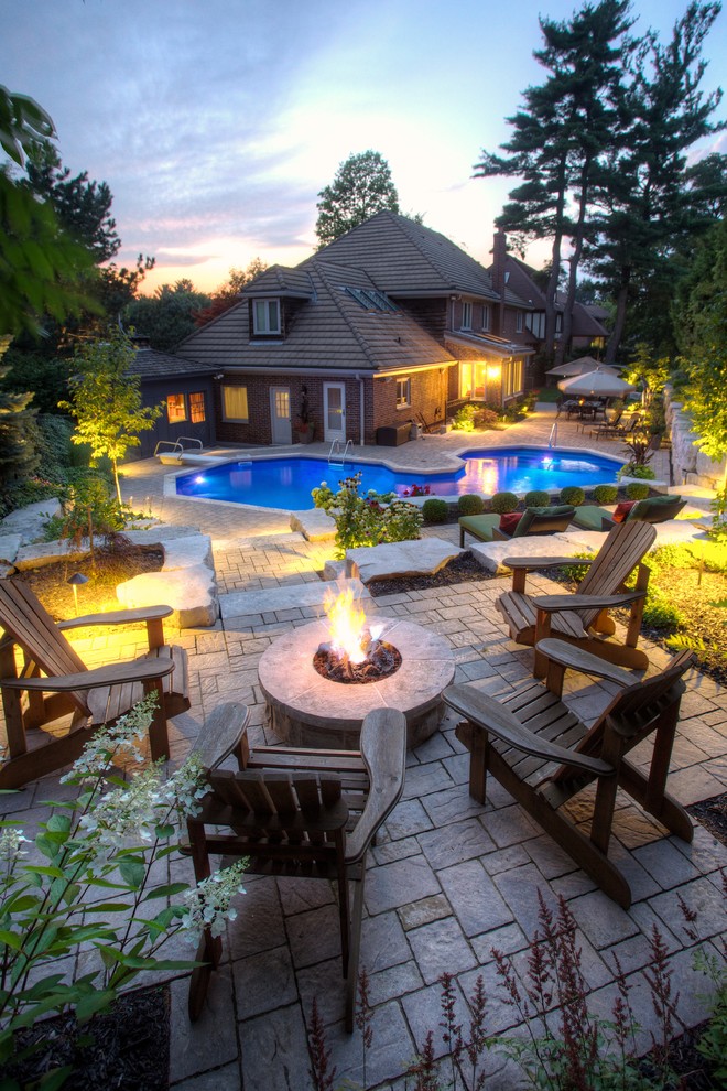 Inspiration for a transitional backyard patio in Toronto with a fire feature.