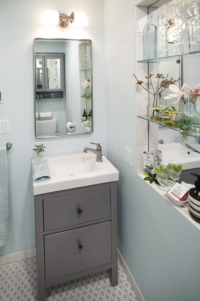 Inspiration for a small contemporary 3/4 bathroom in Seattle with shaker cabinets, grey cabinets, blue tile, ceramic tile, blue walls, porcelain floors, solid surface benchtops, grey floor, an open shower and white benchtops.