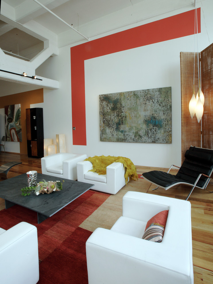 Inspiration for a contemporary living room in Boston with multi-coloured walls and light hardwood floors.