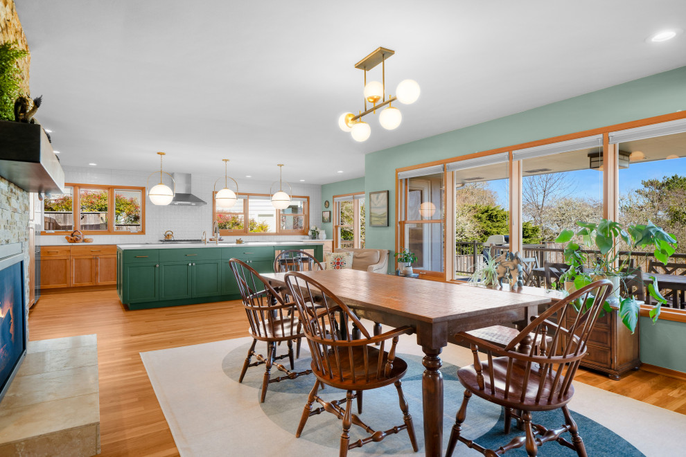 Transitional l-shaped medium tone wood floor kitchen photo with shaker cabinets, white backsplash, an island and white countertops