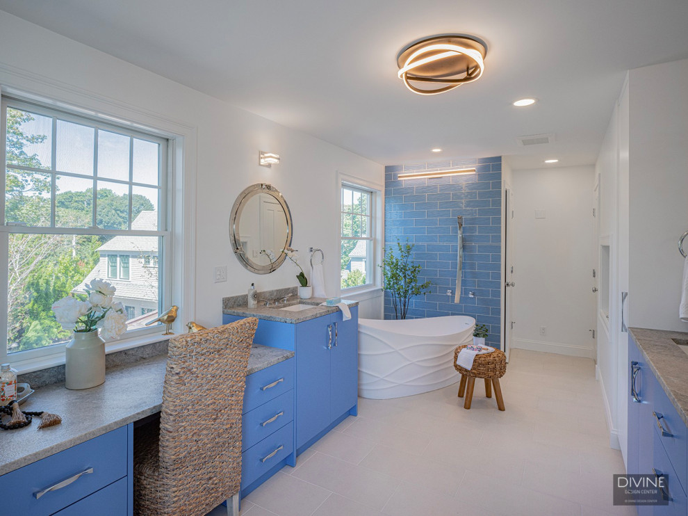 Inspiration for an expansive traditional bathroom in Boston with glass-front cabinets, blue cabinets, a freestanding bath, a corner shower, blue tiles, blue walls, a hinged door, a shower bench, double sinks, ceramic flooring and white floors.