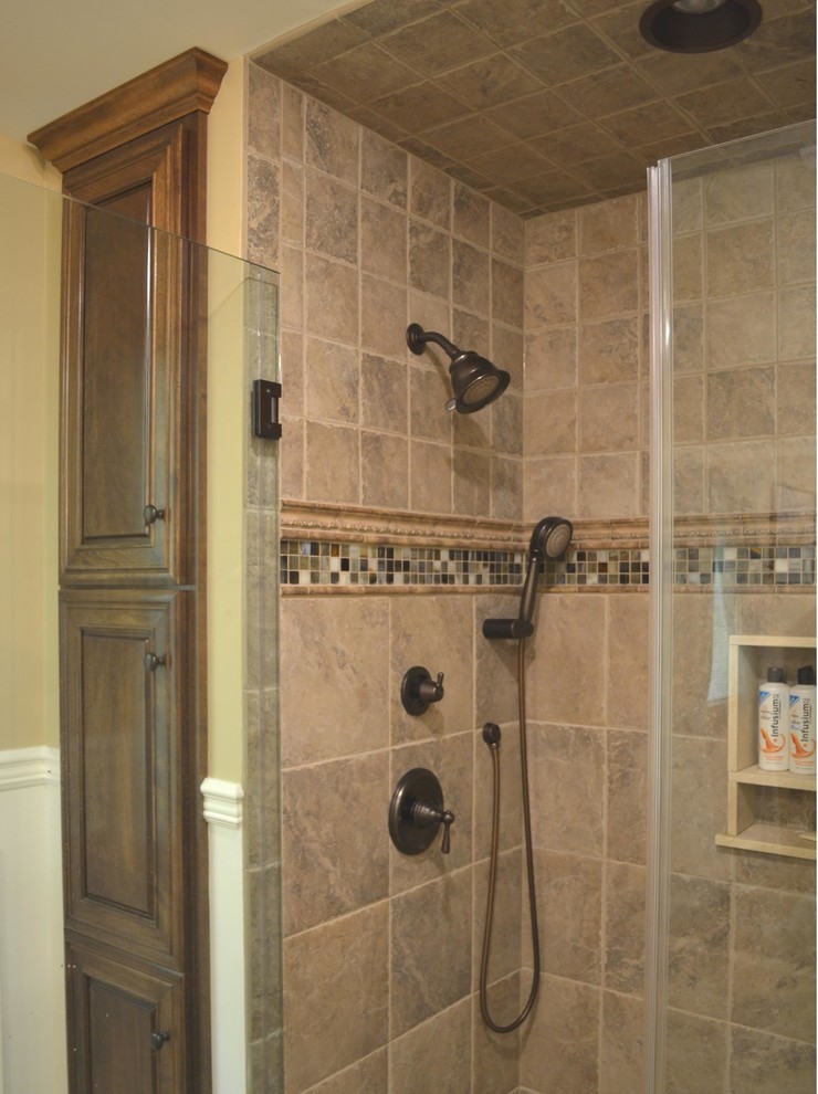 Large traditional master bathroom in Philadelphia with dark wood cabinets, an alcove shower, brown tile, ceramic tile, raised-panel cabinets, a two-piece toilet, beige walls, light hardwood floors, an undermount sink and marble benchtops.
