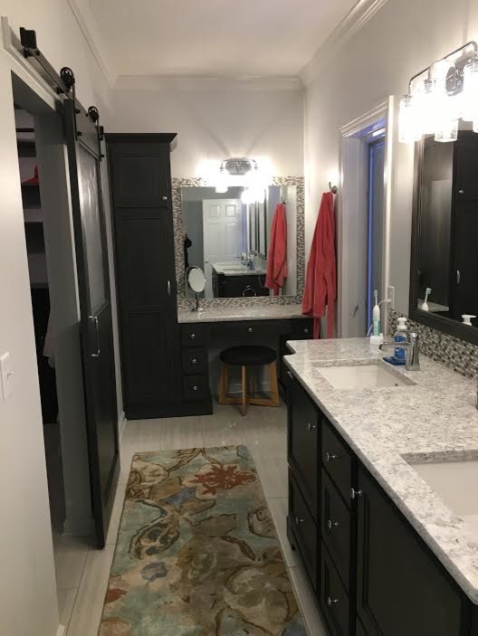 Alcove shower - mid-sized transitional master gray tile and porcelain tile porcelain tile and beige floor alcove shower idea with recessed-panel cabinets, dark wood cabinets, beige walls, an undermount sink, granite countertops and a hinged shower door
