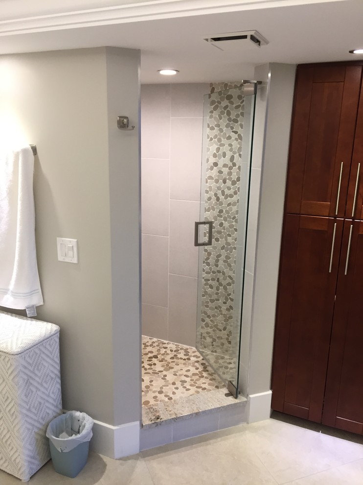 Example of a mid-sized transitional master gray tile and porcelain tile gray floor corner shower design in Miami with shaker cabinets, dark wood cabinets, gray walls, an undermount sink, granite countertops and a hinged shower door