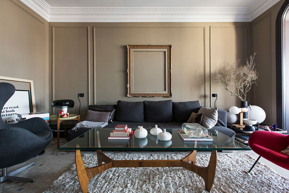 This is an example of a mid-sized eclectic formal enclosed living room in Barcelona with brown walls, no fireplace and no tv.