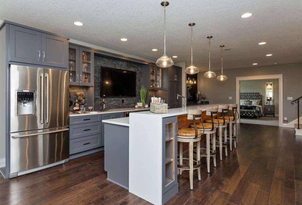 Eat-in kitchen - mid-sized transitional l-shaped dark wood floor eat-in kitchen idea with shaker cabinets, gray cabinets, solid surface countertops, gray backsplash, stone tile backsplash, stainless steel appliances and an island