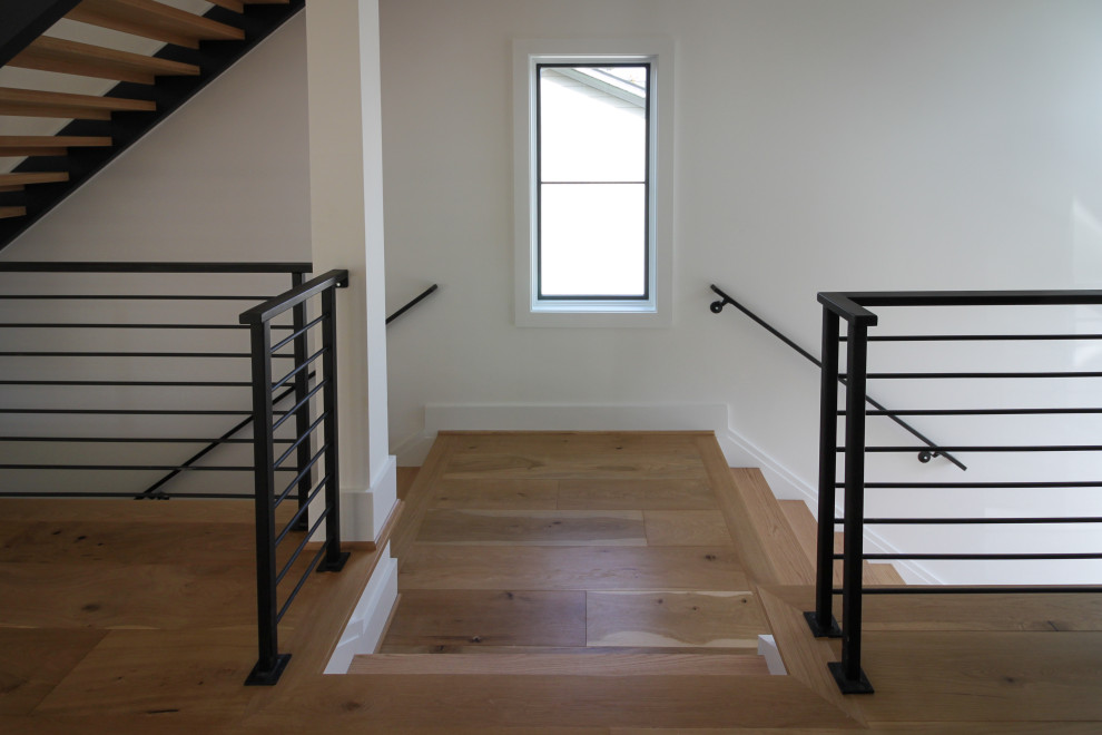 Design ideas for a medium sized contemporary wood straight metal railing staircase in DC Metro.