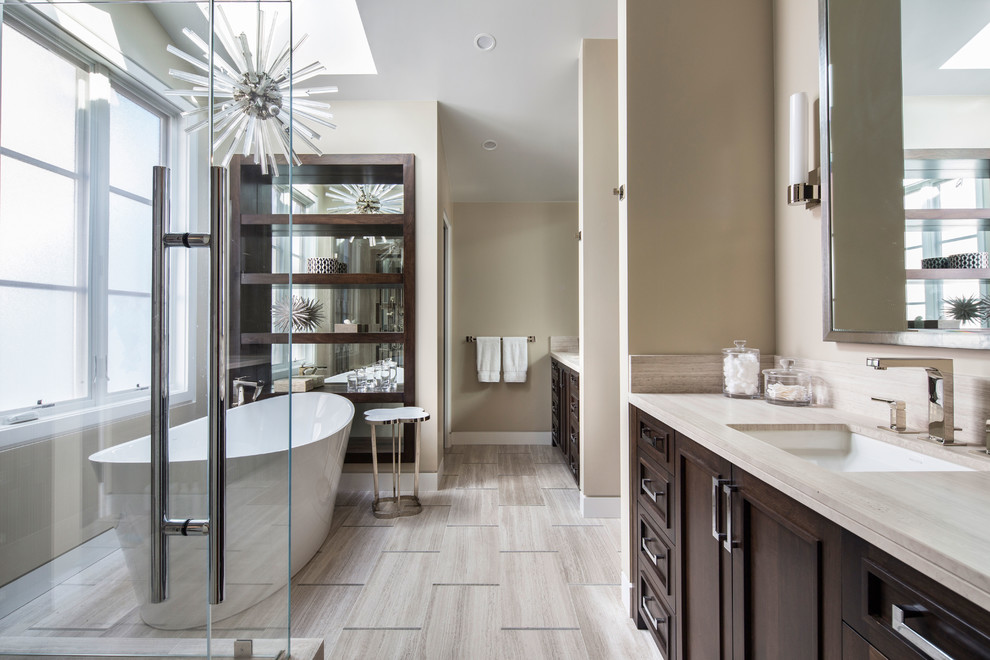 Photo of an expansive beach style master bathroom in Orange County with a freestanding tub and a double shower.