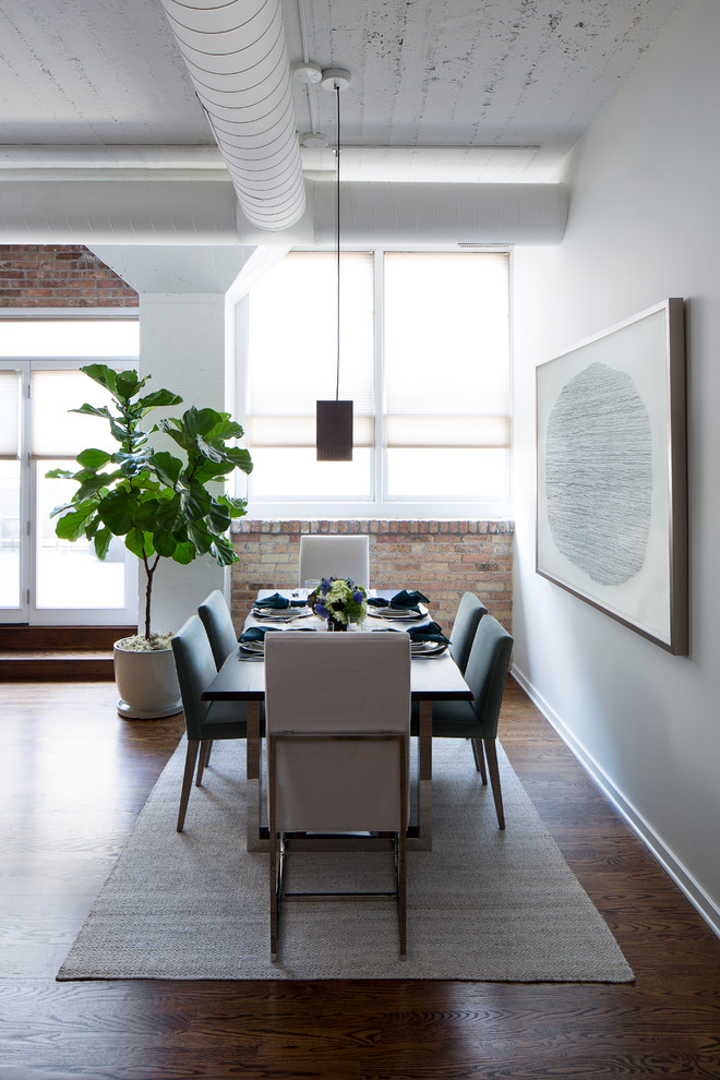Photo of a mid-sized contemporary dining room in Chicago with beige walls and dark hardwood floors.