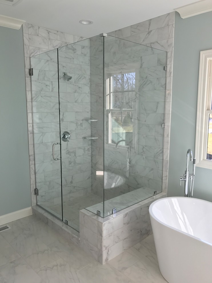 This is an example of a large contemporary master bathroom in Cleveland with a freestanding tub, an alcove shower, gray tile, porcelain tile, grey walls, porcelain floors and grey floor.