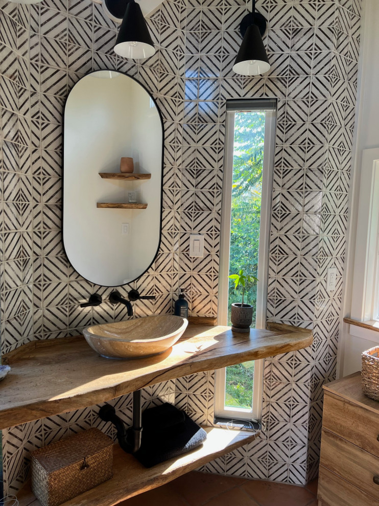 Bathroom - mid-sized farmhouse master black and white tile and ceramic tile terra-cotta tile, orange floor, single-sink, exposed beam and wood wall bathroom idea in Hawaii with open cabinets, beige cabinets, a bidet, white walls, a vessel sink, wood countertops, beige countertops, a niche and a floating vanity