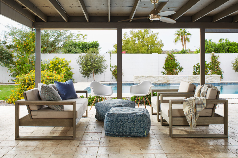Mid-sized transitional backyard patio in Phoenix with tile and a roof extension.
