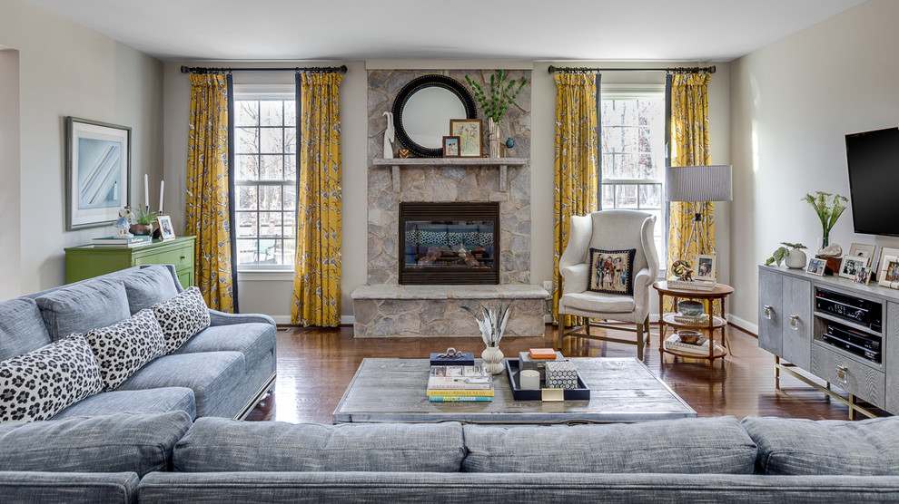 Large eclectic open concept family room in DC Metro with grey walls, dark hardwood floors, a standard fireplace, a stone fireplace surround, a wall-mounted tv and brown floor.