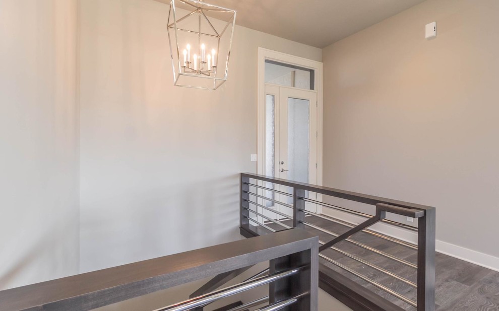 Front door - small transitional medium tone wood floor front door idea with gray walls and a glass front door