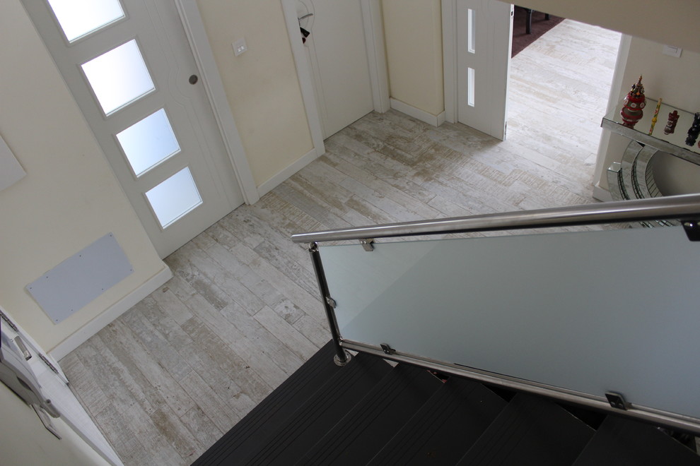 Imagen de puerta principal clásica renovada pequeña con suelo de madera pintada y puerta blanca