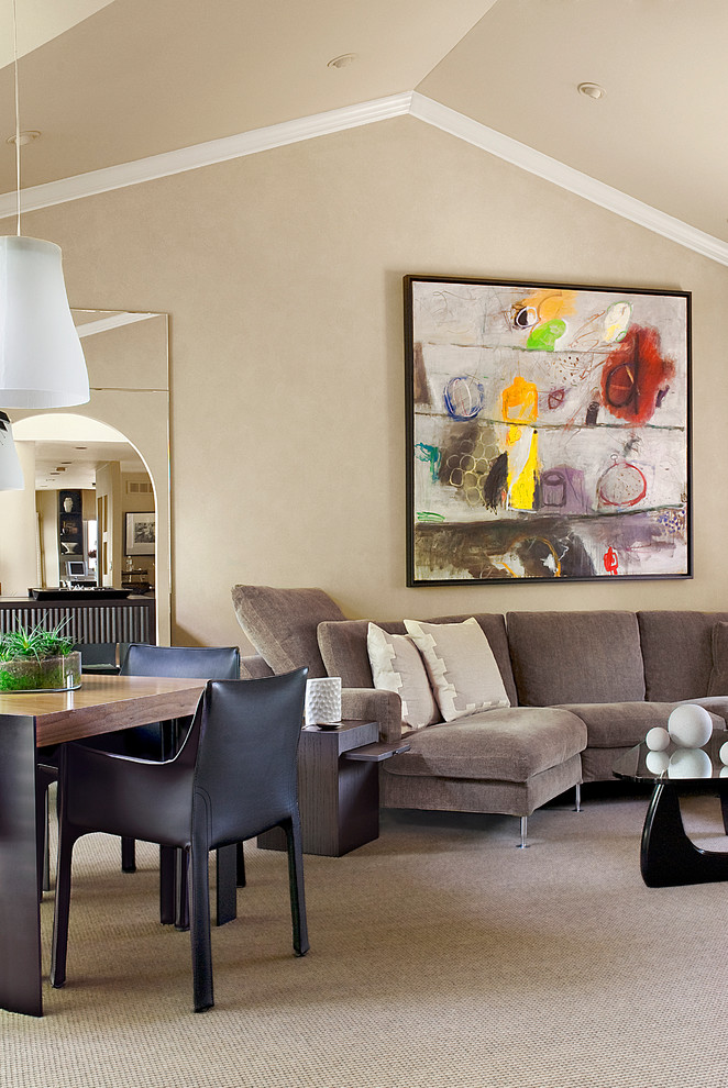 This is an example of a contemporary family room in Detroit with beige walls and carpet.