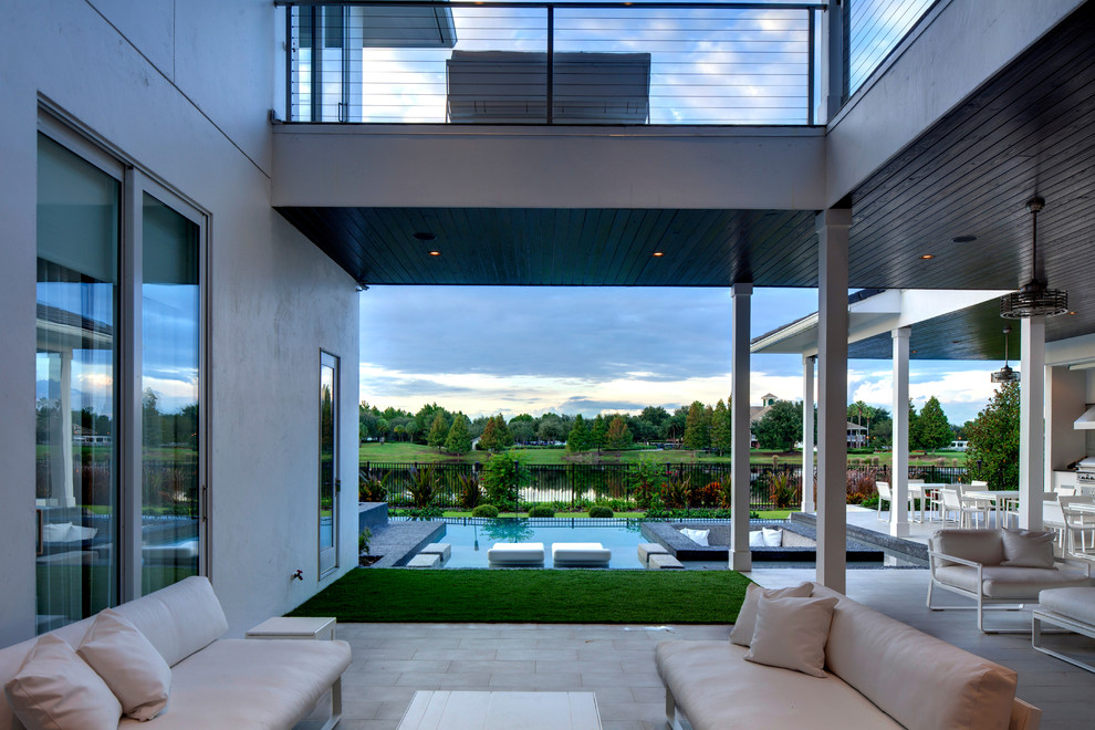 Inspiration for a contemporary patio in Orlando with a roof extension.