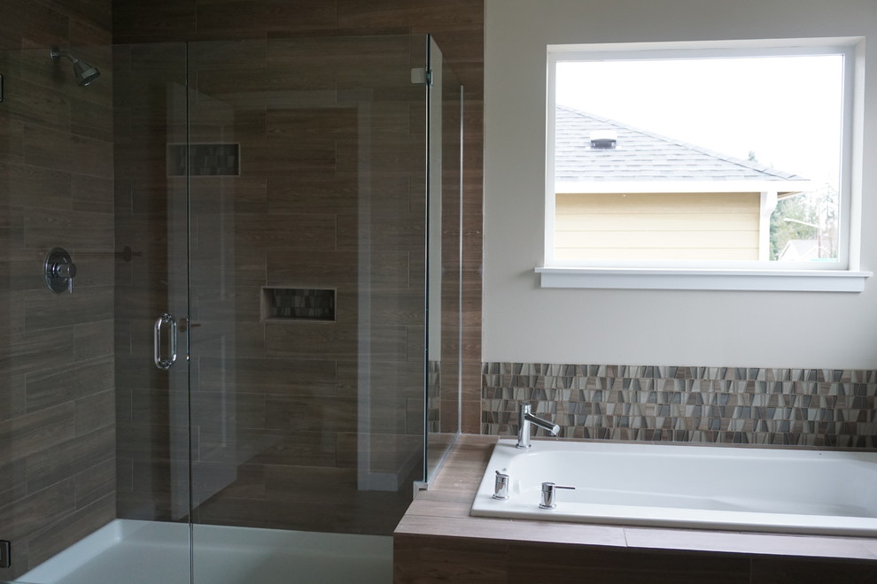Inspiration for a large arts and crafts master bathroom in Seattle with flat-panel cabinets, dark wood cabinets, a drop-in tub, a corner shower, beige tile, brown tile, glass tile, beige walls, laminate floors, a trough sink and laminate benchtops.