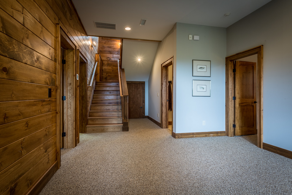Mid-sized mountain style walk-out carpeted and beige floor basement photo in Charlotte with gray walls and no fireplace