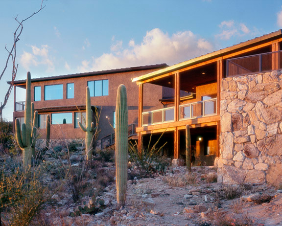 Photo of a large traditional split-level stucco brown exterior in Phoenix.