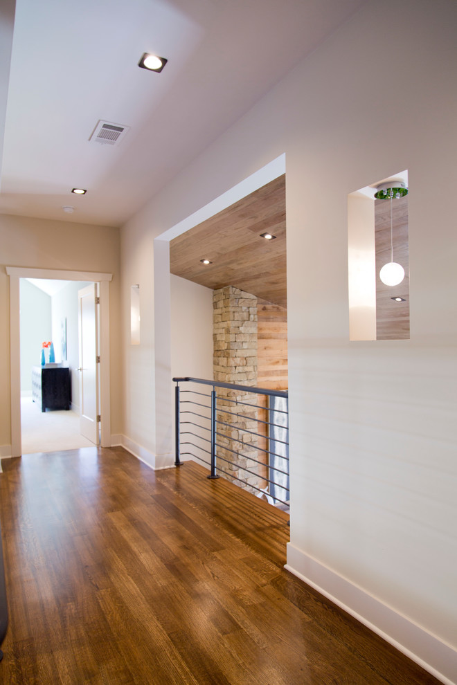 Design ideas for a large transitional hallway in Kansas City with beige walls and dark hardwood floors.