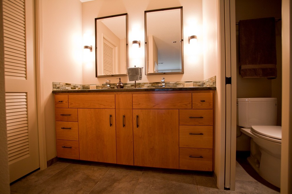 Photo of a mid-sized asian master bathroom in Portland with flat-panel cabinets, brown cabinets, an alcove shower, a two-piece toilet, orange tile, glass tile, orange walls, porcelain floors, an undermount sink, granite benchtops, multi-coloured floor, multi-coloured benchtops and an open shower.