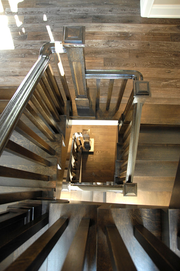 Large transitional wood floating staircase in Toronto with wood risers.