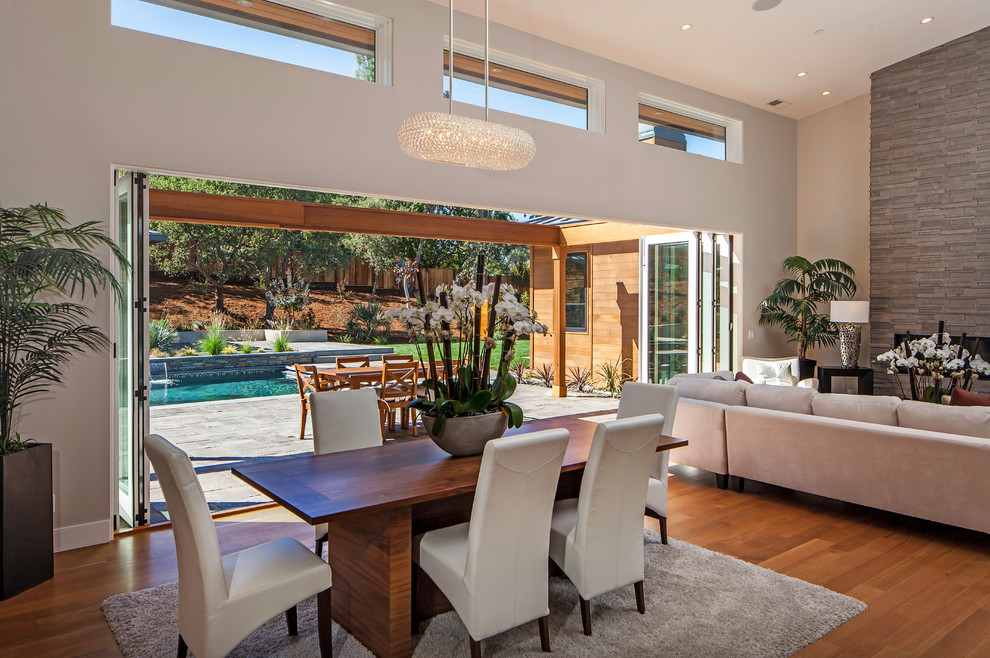 Design ideas for a contemporary open plan dining in San Francisco with white walls and medium hardwood floors.